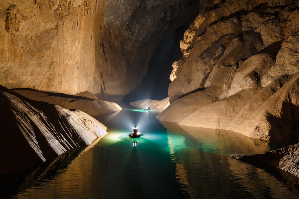 Cavers on a lake near the exit of Hang Son Doong, Phong Nha Ke Bang, Vietnam